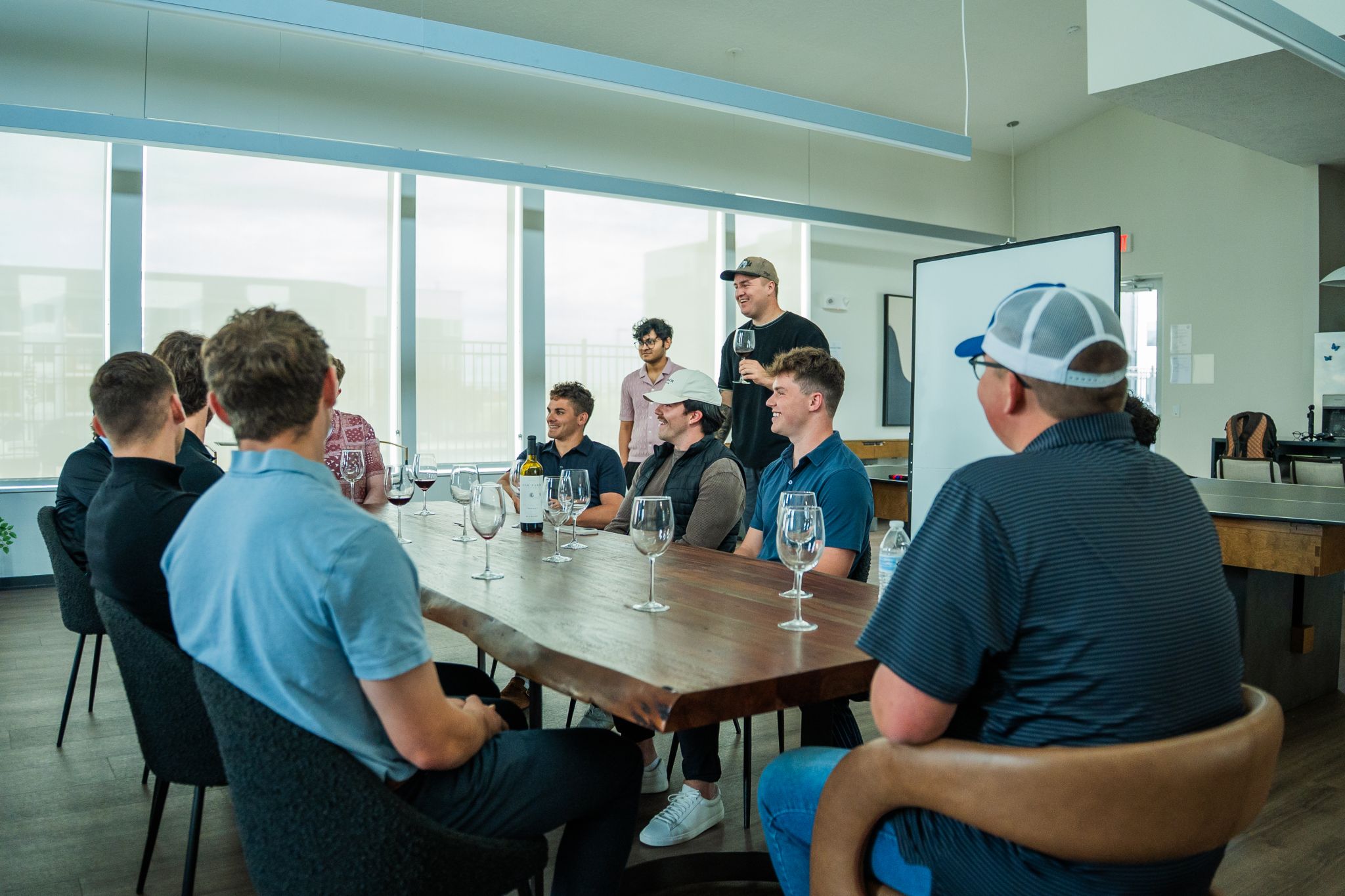 A community of ambitious young founders gathered around a table building AI agencies together